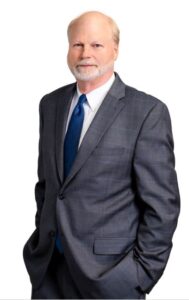 A man in a suit and tie standing up.