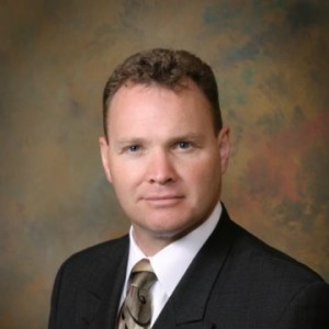 A man in suit and tie posing for the camera.